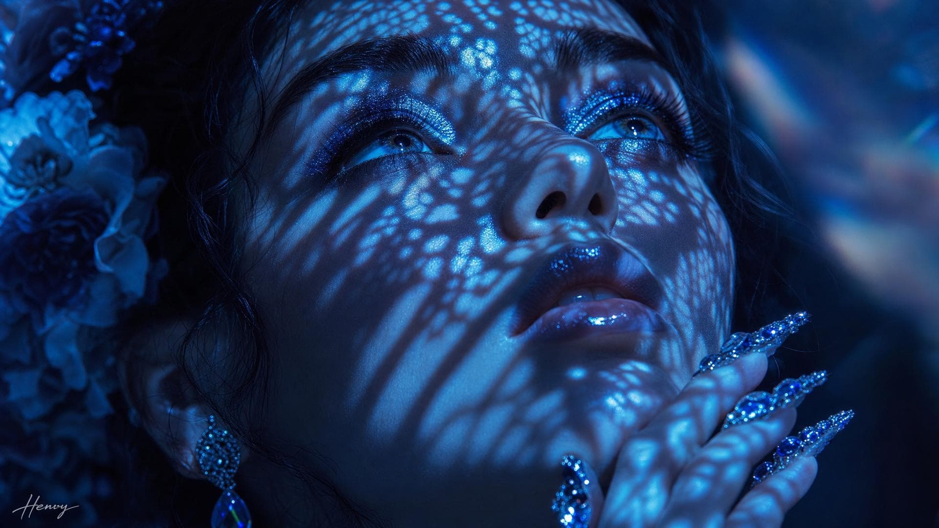 Create a high-fashion cinematic portrait for a luxury beauty campaign.Subject & Action: An extreme close-up of a woman's face, looking upward with an intense, contemplative gaze. Her hand is elegantly positioned near her chin, showcasing long, ornate fingernails encrusted with intricate blue crystals and jewels.Lighting & Pattern (The Core): Utilize dramatic Chiaroscuro lighting. A bright cyan light source is projected through a delicate lace stencil, casting intricate, dappled, and complex lace-patterned shadows across her forehead, eyes, and cheeks. The highlights should be electric blue, while the shadows are deep, opaque black.Visual Style & Texture: High-contrast monochrome blue aesthetic. Focus on hyper-realistic textures: shimmering blue glitter eyeshadow, a wet-look gloss on the lips, and the sharp, crystalline refraction of the jewel-encrusted nails.Composition & Camera: Macro photography style; extremely shallow depth of field focusing sharply on the eyes and the lace patterns on the skin; low-angle shot; high-resolution; 16:9 aspect ratio.Constraints: No skin textures other than those lit by the pattern; no warm colors; no background clutter; add henry Signature; ### ️⃣ Add the “Fusion‑Style” Overlays Overlay What it brings to the table ------------------------------------- Surreal‑Dream‑Matrix Unexpected juxtapositions, impossible perspectives, or a fever‑dream atmosphere that bends reality. Hyper‑Chromatic‑Glaze A whisper of iridescent colour that…